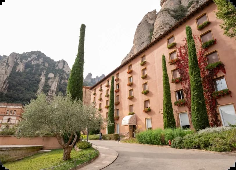 Facade of Hotel Abat Cisneros with gardens at the foot of Montserrat