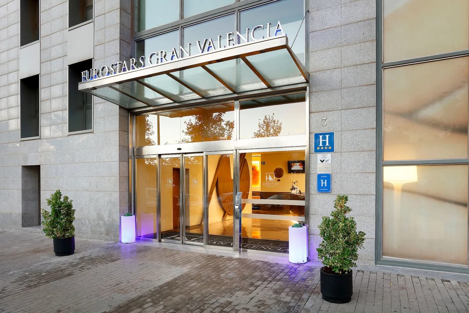 Entrance of Eurostars Gran Valencia hotel with stone facade in Valencia