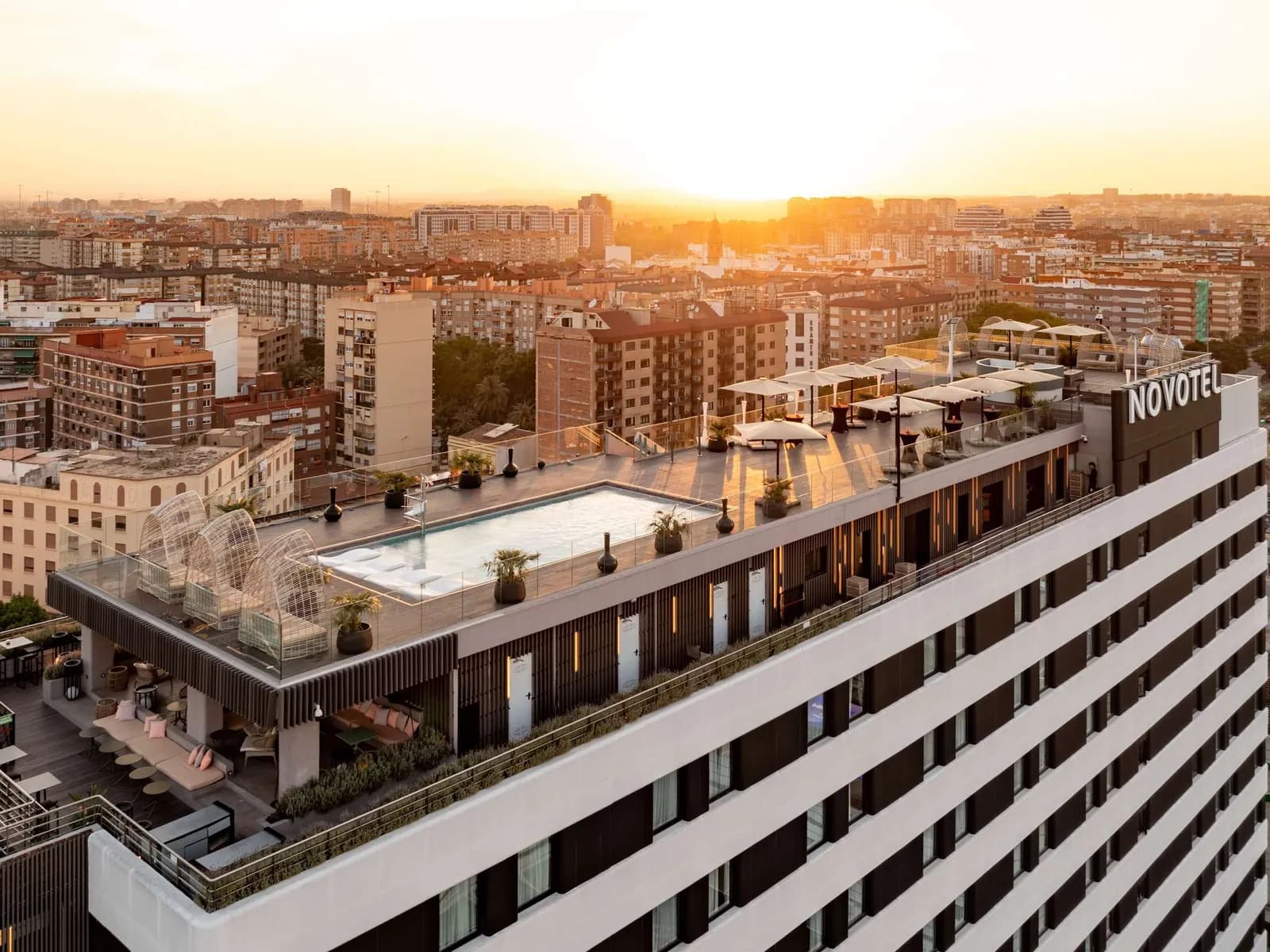 Aerial view of Novotel Valencia Lavant and its rooftop at sunset in Valencia