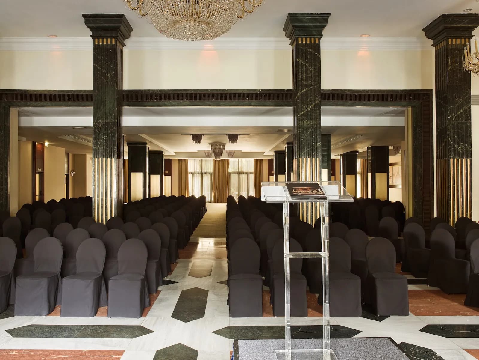 Large hall at InterContinental Madrid with marble columns and rows of chairs
