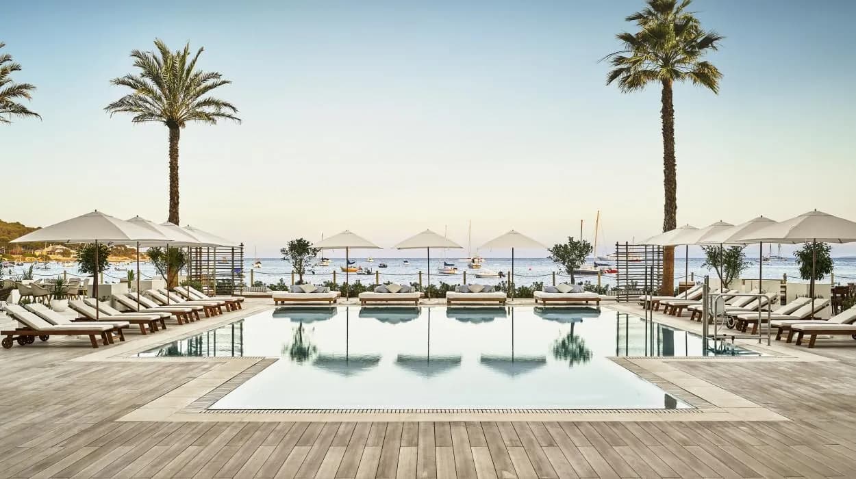 Pool and loungers by the sea at Nobu Hotel Ibiza Bay in Ibiza