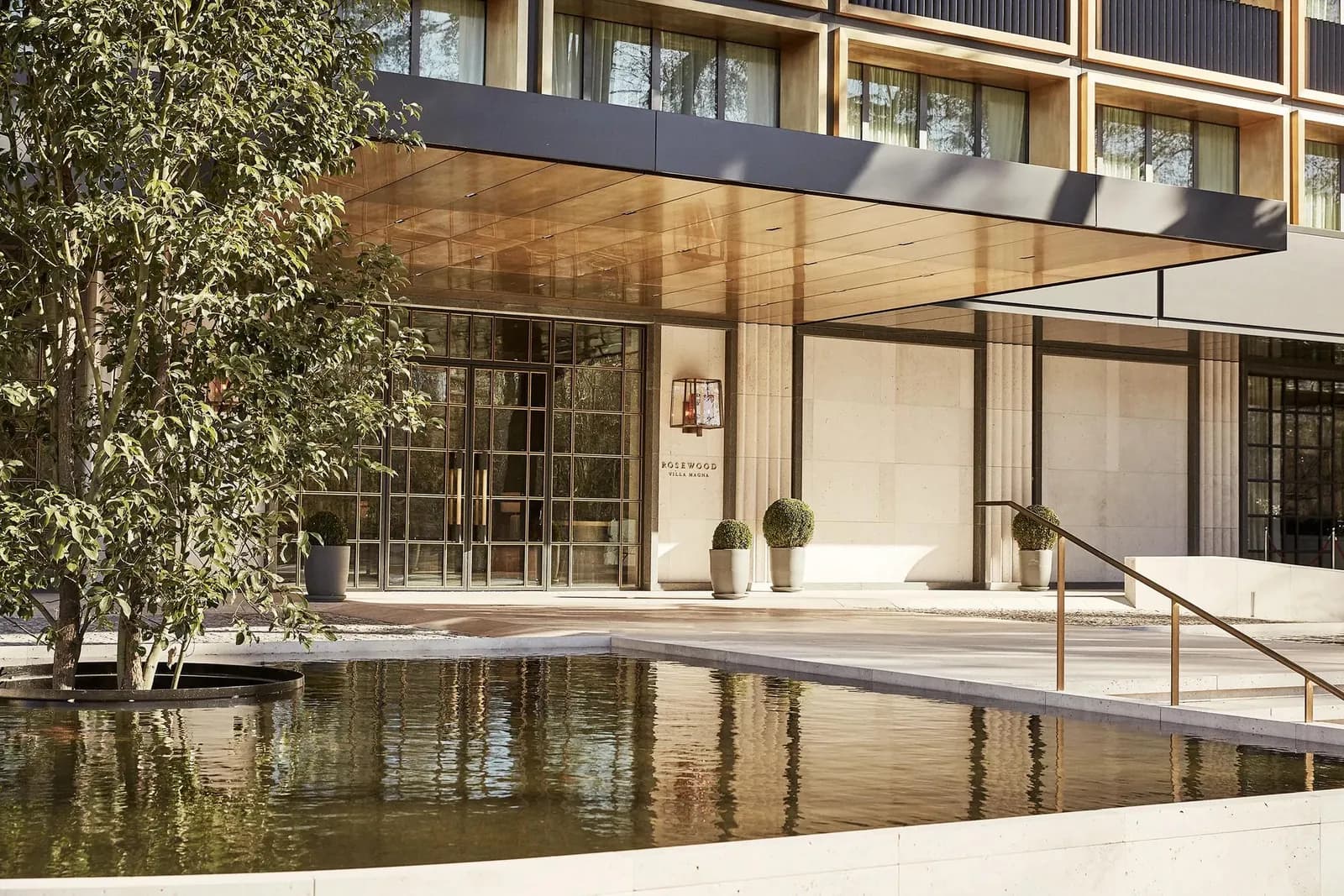 Rosewood Villa Magna facade with a reflecting pool in Madrid