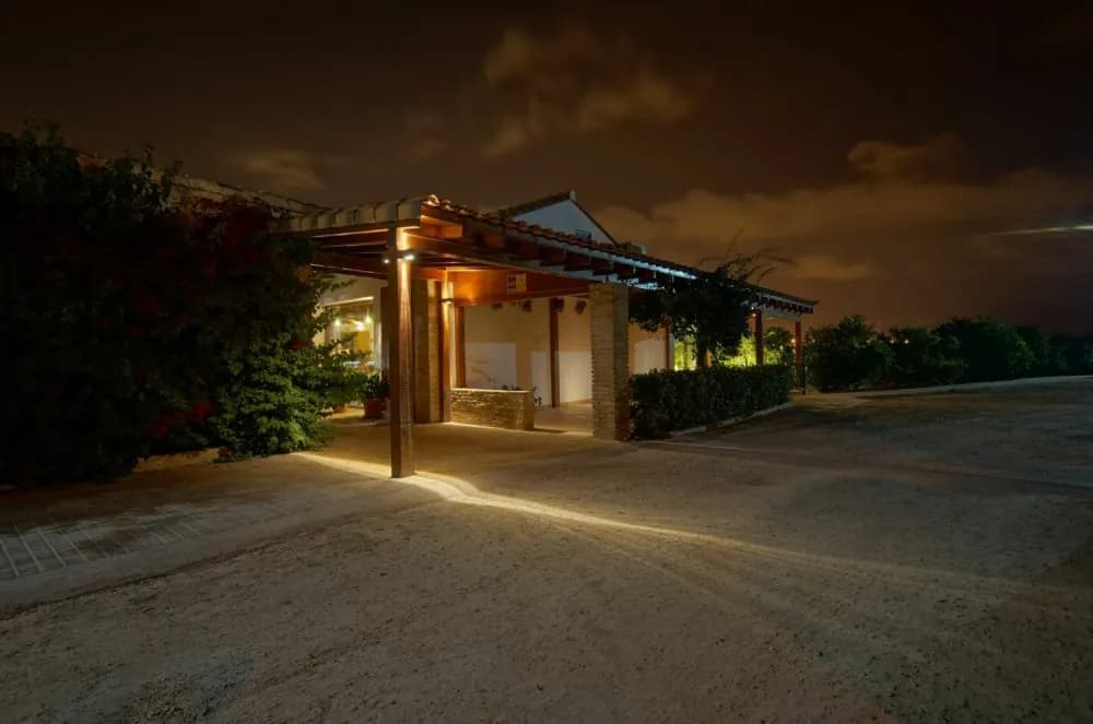 Night view of the lit Alquería del Brosquil building near Valencia