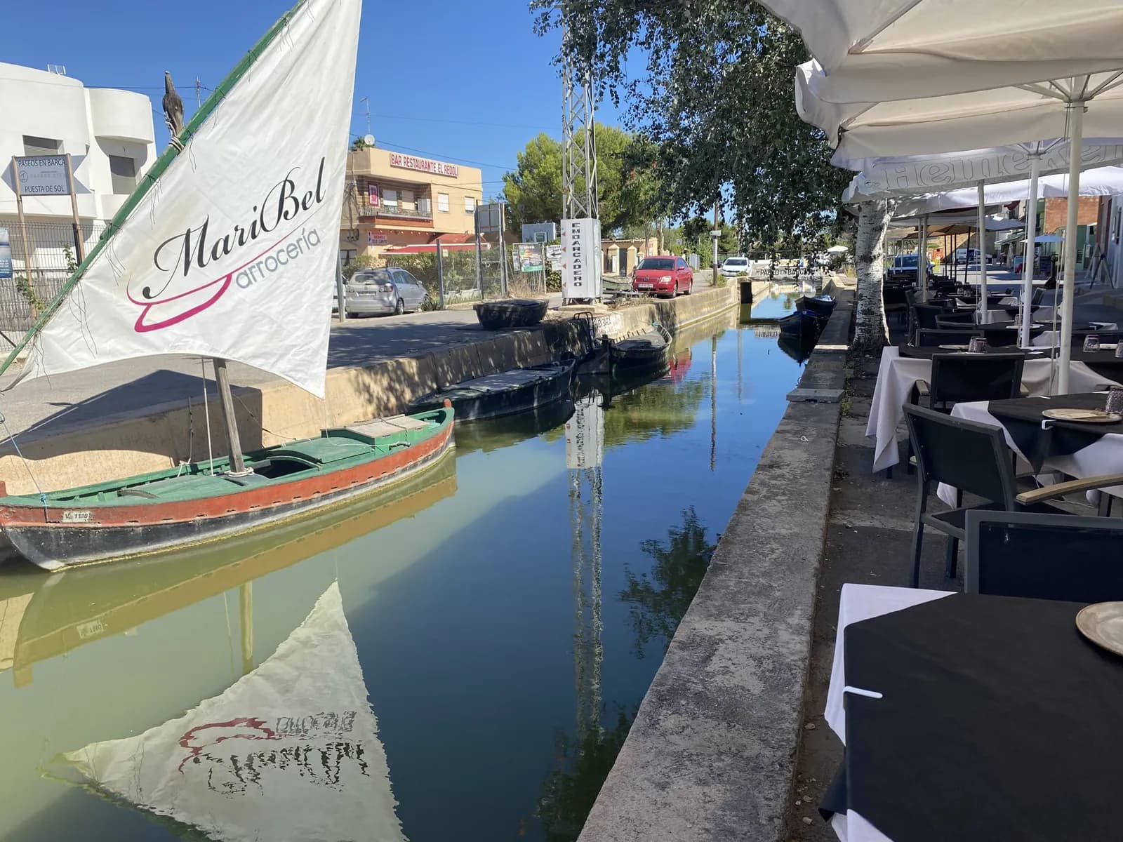 Arrocería Maribel terrace by the canal with boat and parasols