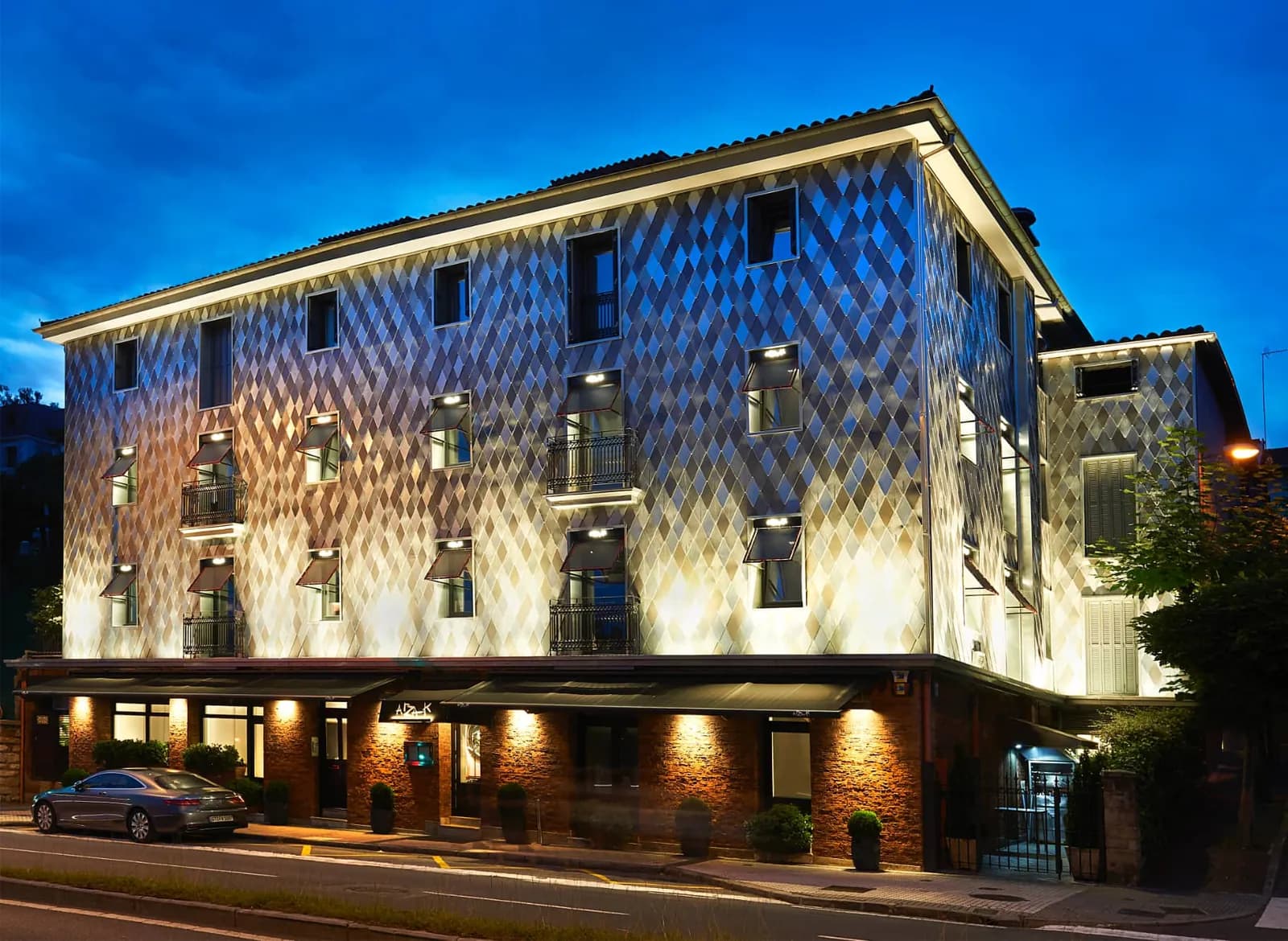 Illuminated facade of Arzak restaurant at dusk in Donostia