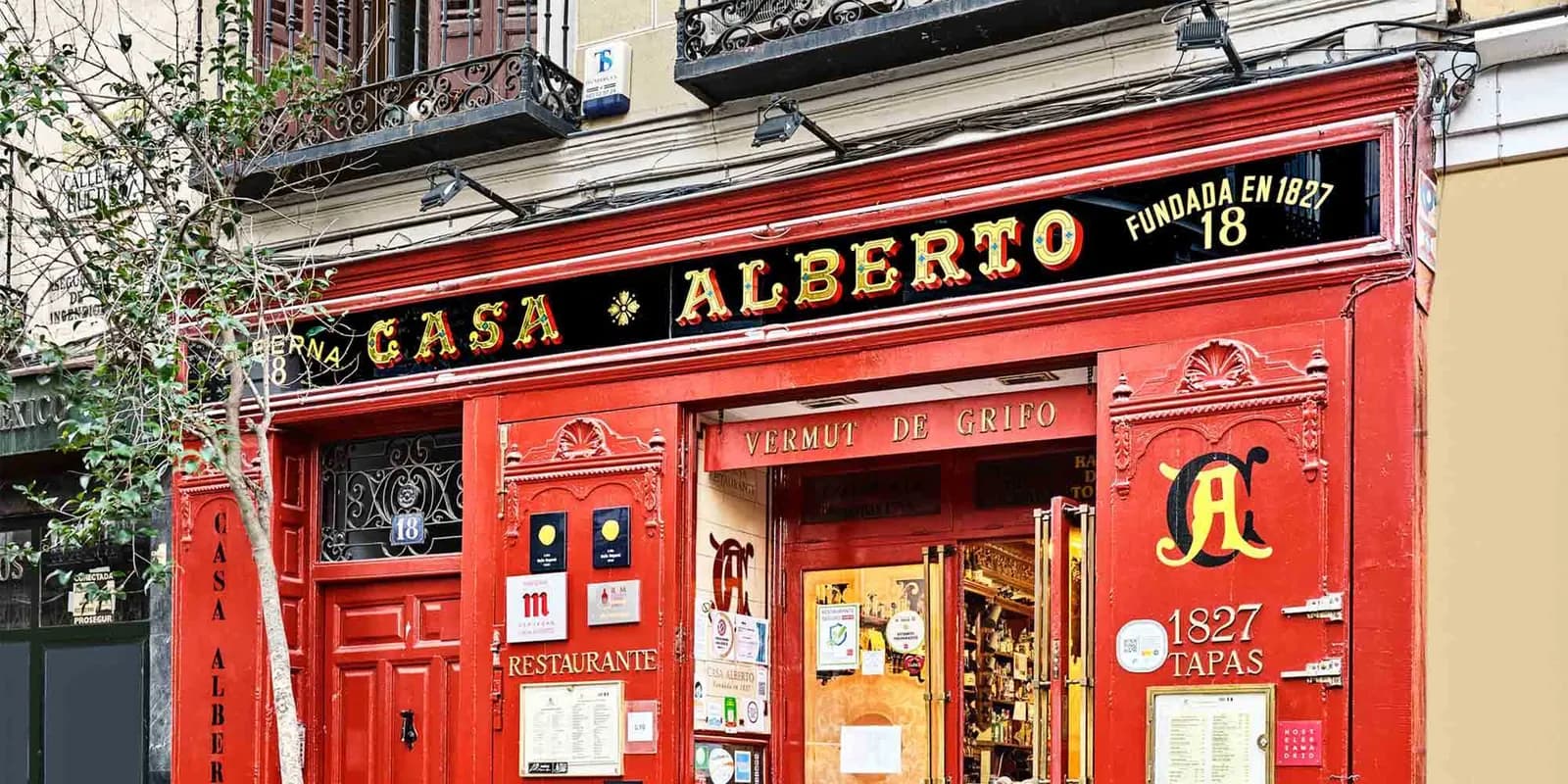 Red facade of Casa Alberto with its Fundada en 1827 sign in Madrid