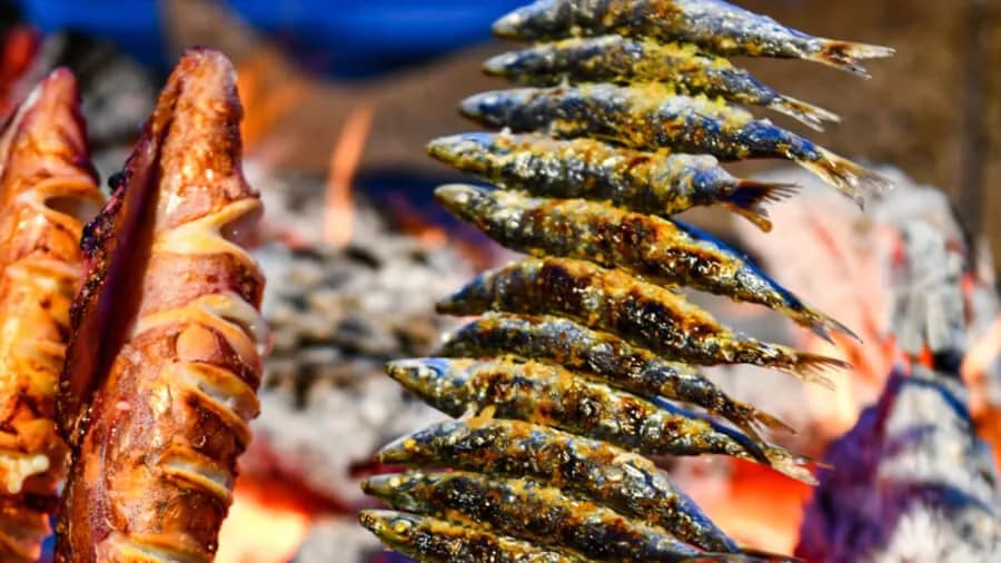 Sardines on skewers grilled over wood fire at El Caleño restaurant in Pedregalejo