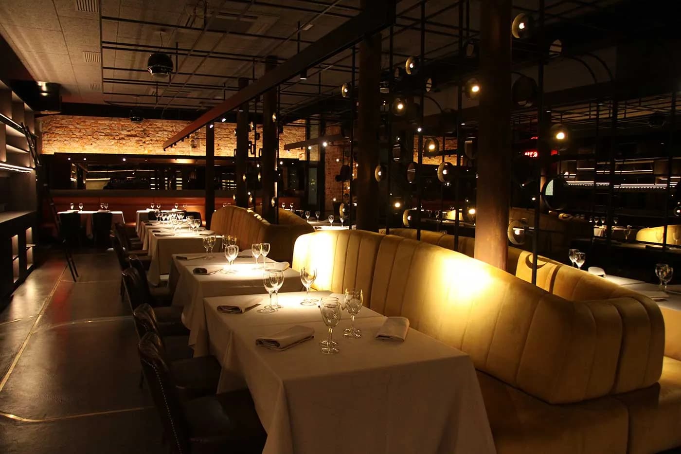 Dining room of La Despensa Etxanobe in Bilbao with gold banquettes