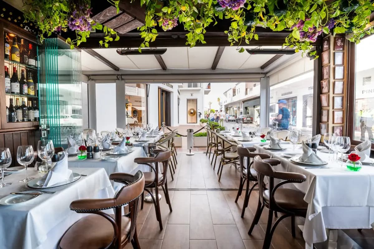Dining room of Los Bandidos restaurant in Puerto Banús with set tables