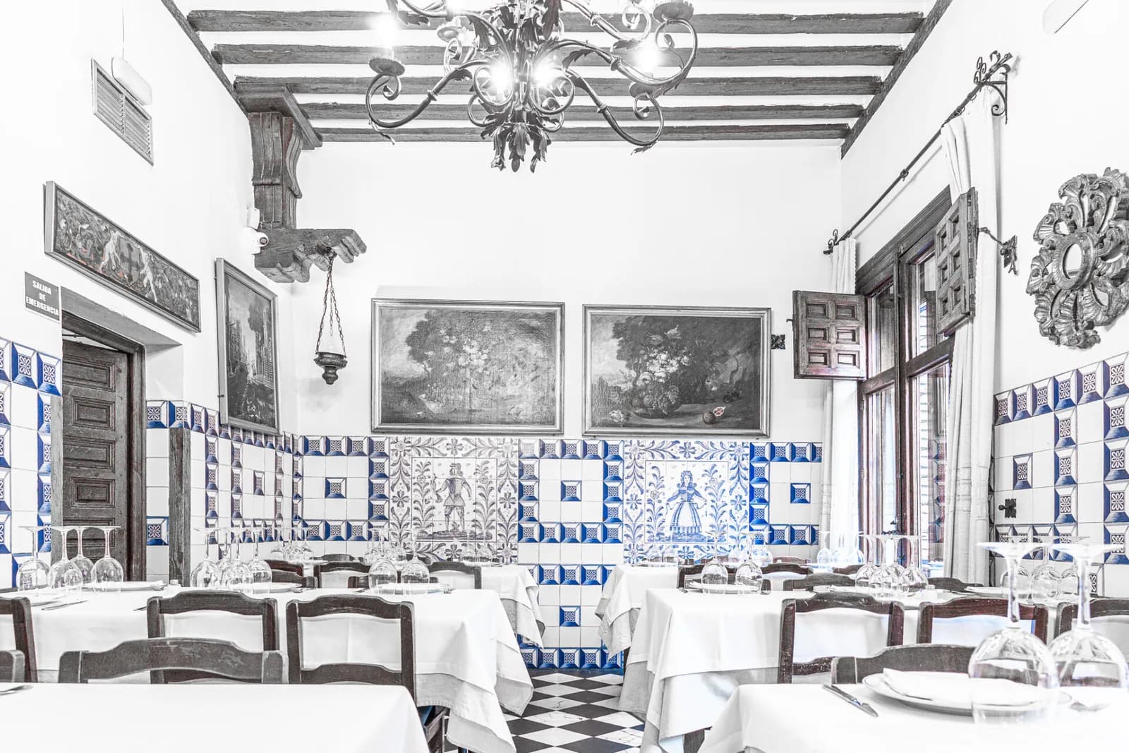 Sobrino de Botín dining room in Madrid, set tables beneath blue and white tiles