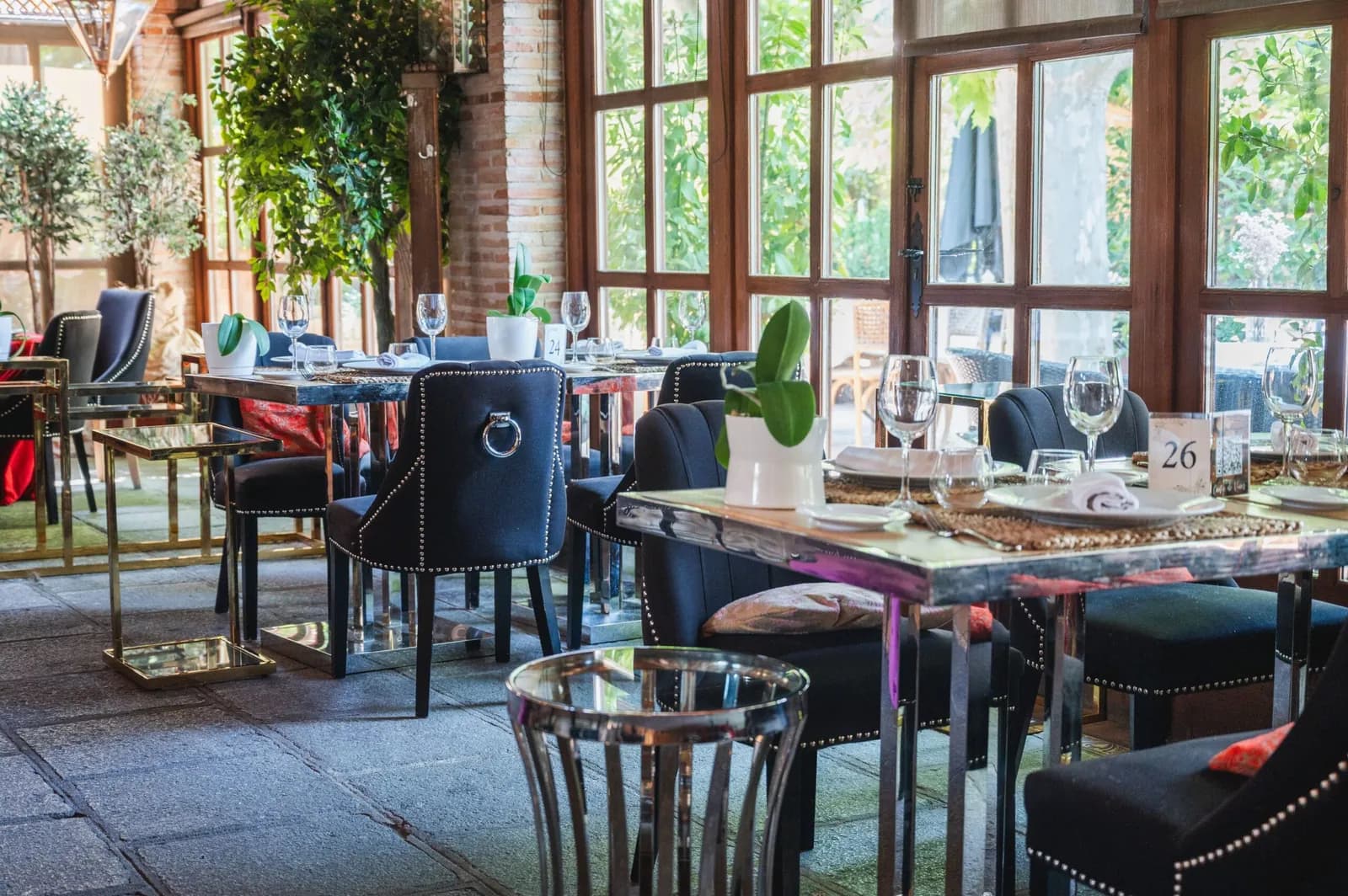 Venta de Aires restaurant dining room in Toledo, set tables by large windows
