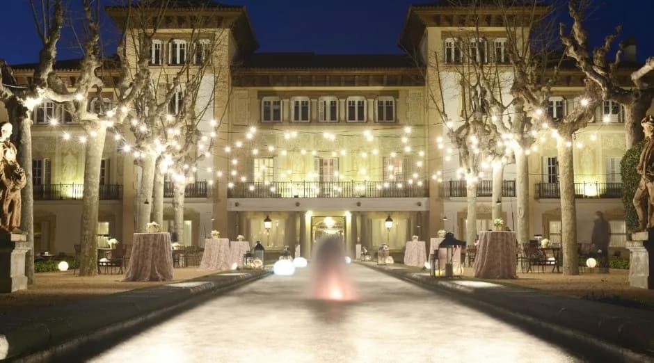 Illuminated facade of Finca Mas Solers near Barcelona in the evening, for corporate events