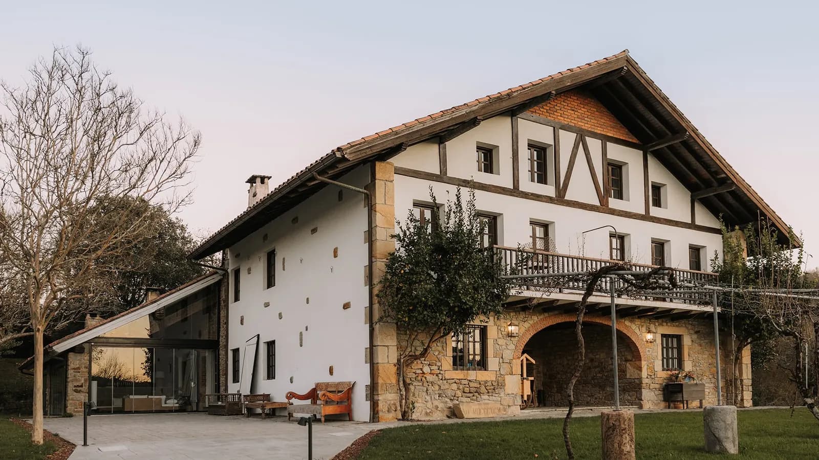 Facade of Finca Viñedos de Butrón near Bilbao, white Basque house with timber frame