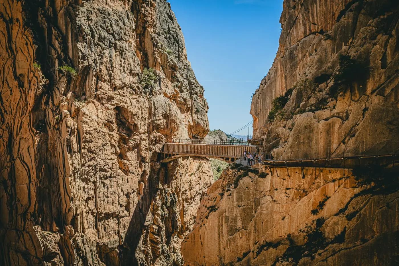Houten wandelpad hangend tussen de rotswanden van de Caminito del Rey