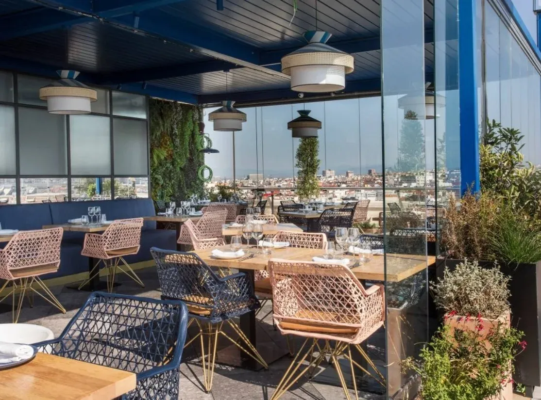 Tables on the glazed terrace of the Azotea at Círculo de Bellas Artes in Madrid