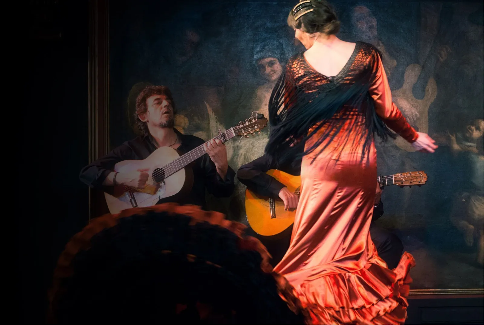 Flamenco show at Corral de la Morería in Madrid, dancer in red dress with guitar