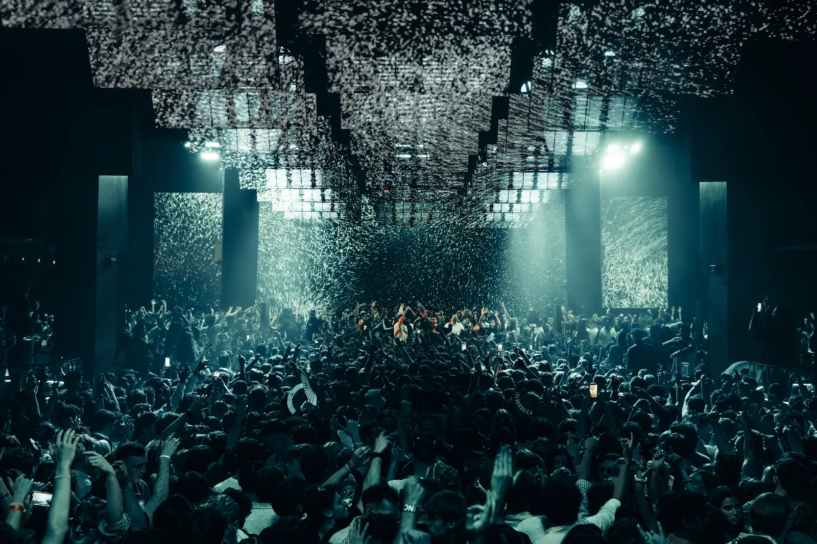 Dense crowd under a lit ceiling inside Hï Ibiza club
