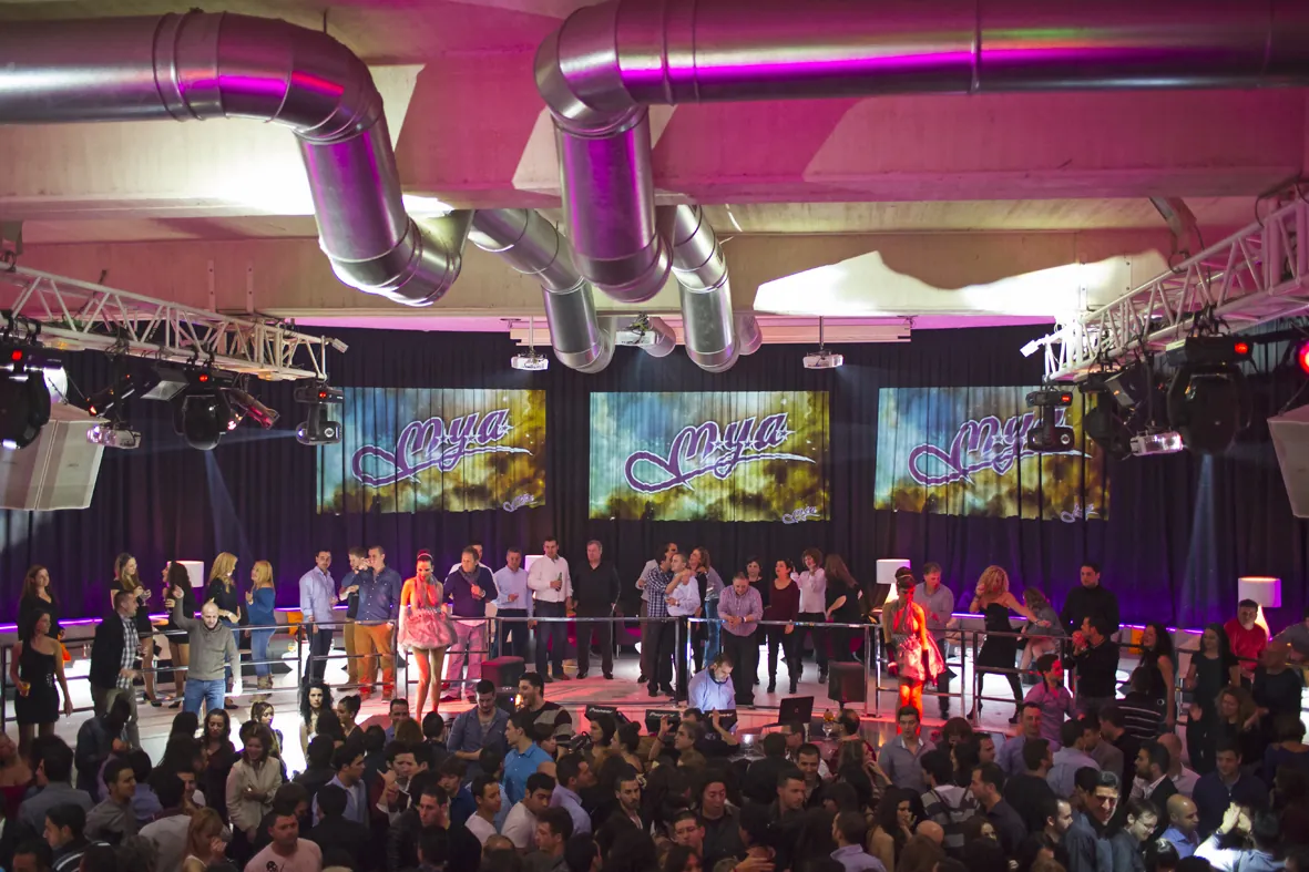 Mya Valencia stage with large crowd in front of screens