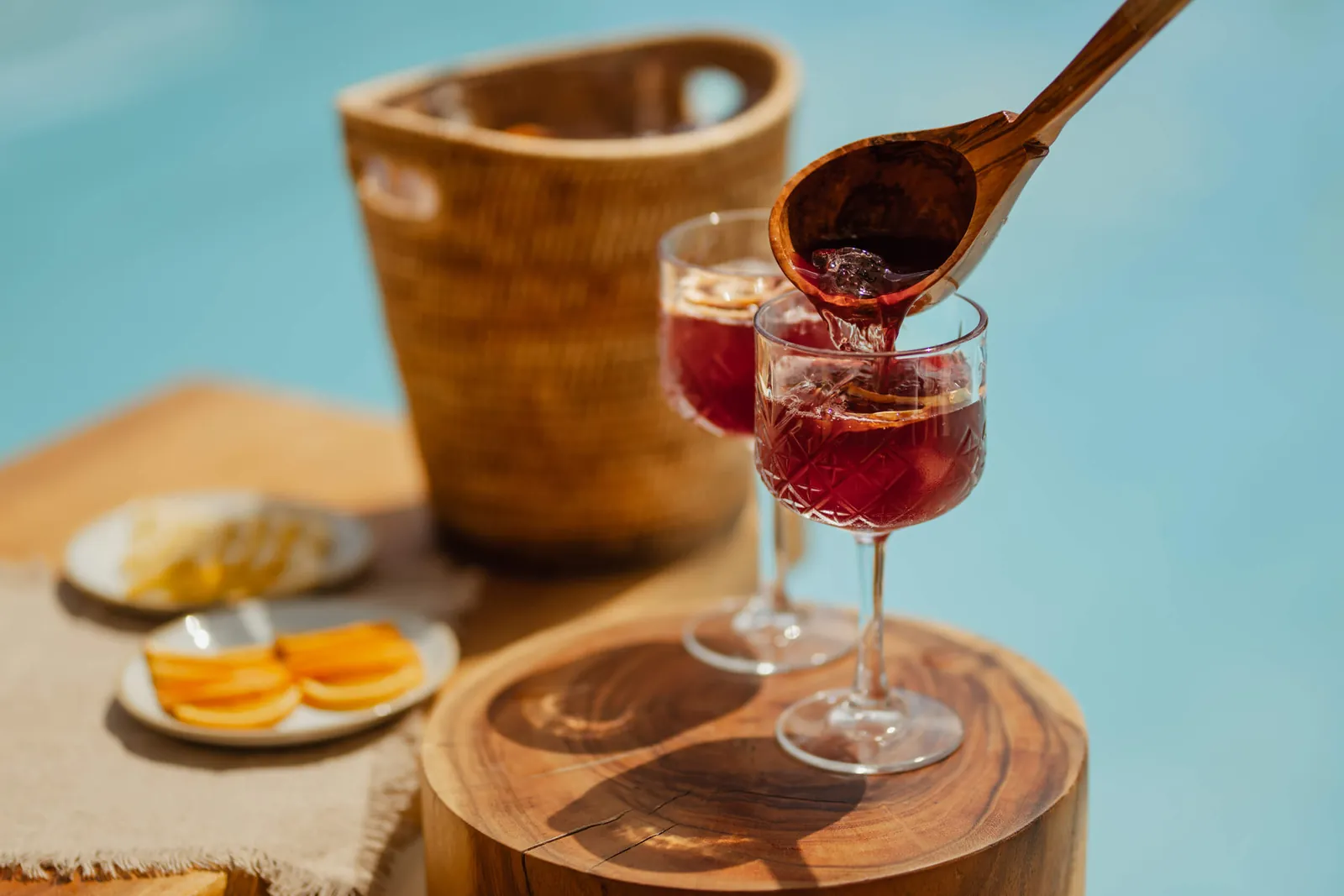 Red cocktails and snacks on a wooden board at Nikki Beach Ibiza