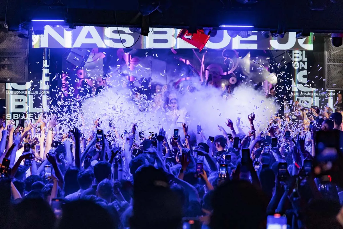 White foam and crowd under blue lights at Opium Barcelona