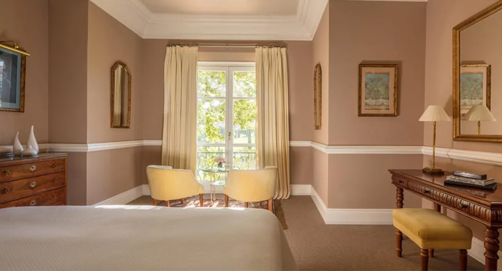 Guest room at Anantara Villa Padierna in Benahavís with white bed and garden-view window