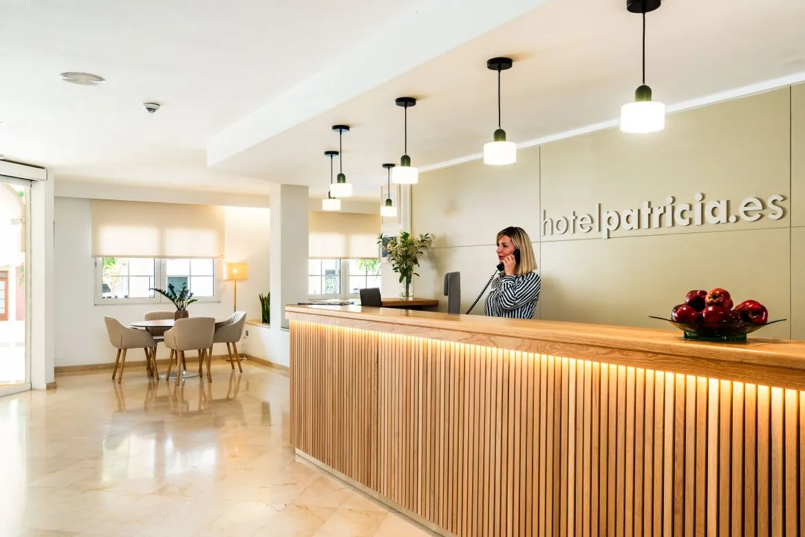 Wooden reception desk at Hotel Menorca Patricia in Ciutadella