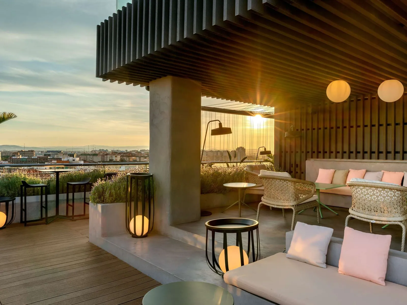 Sky Bar terrace at Novotel Valencia Lavant with sofas at sunset in Valencia