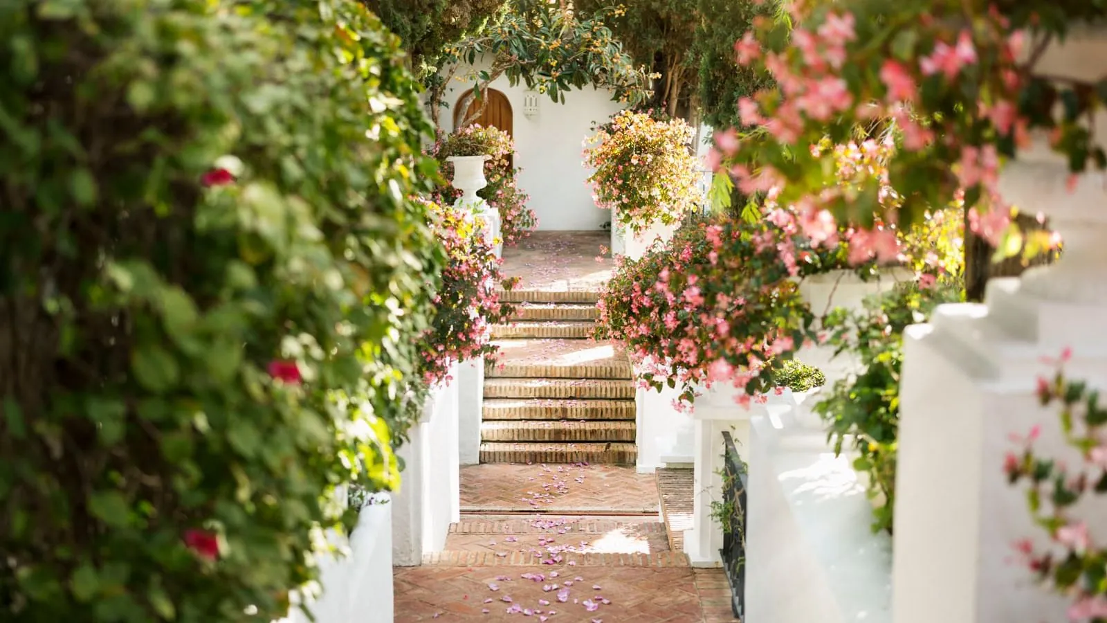 Flower-lined staircase leading to the entrance of Marbella Club Hotel in Marbella