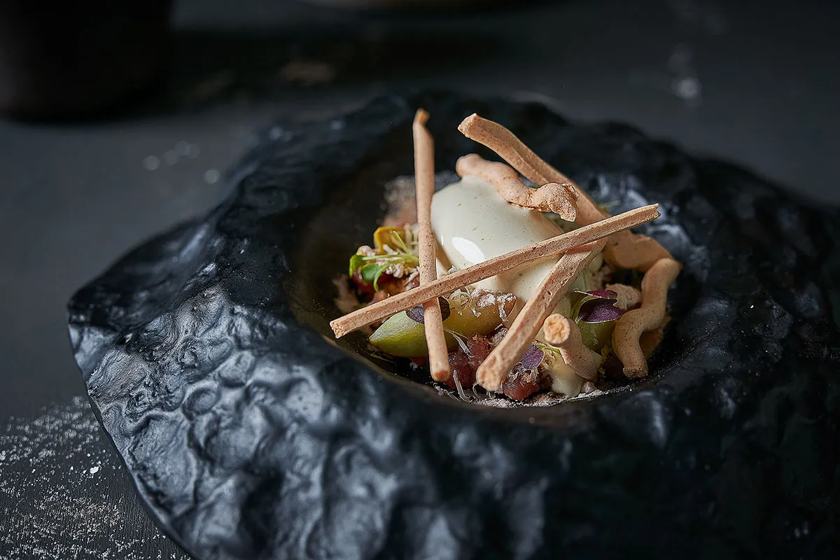 Dish served in a black bowl at Adrián Quetglas in Palma