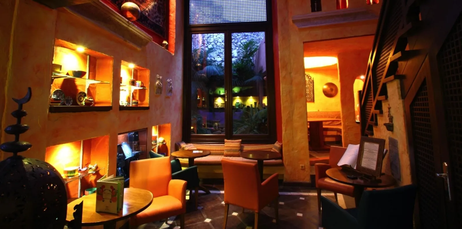 Warmly lit lounge area with armchairs at Amanhavis in Benahavís, Andalusia