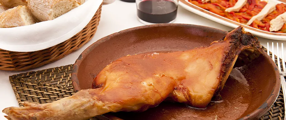 Roasted meat dish served at Asador Real in Madrid