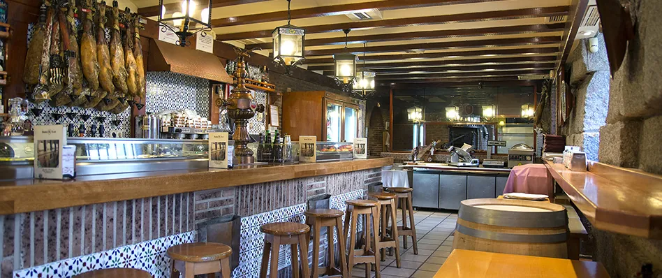 Asador Real bar with hanging cured hams in Madrid