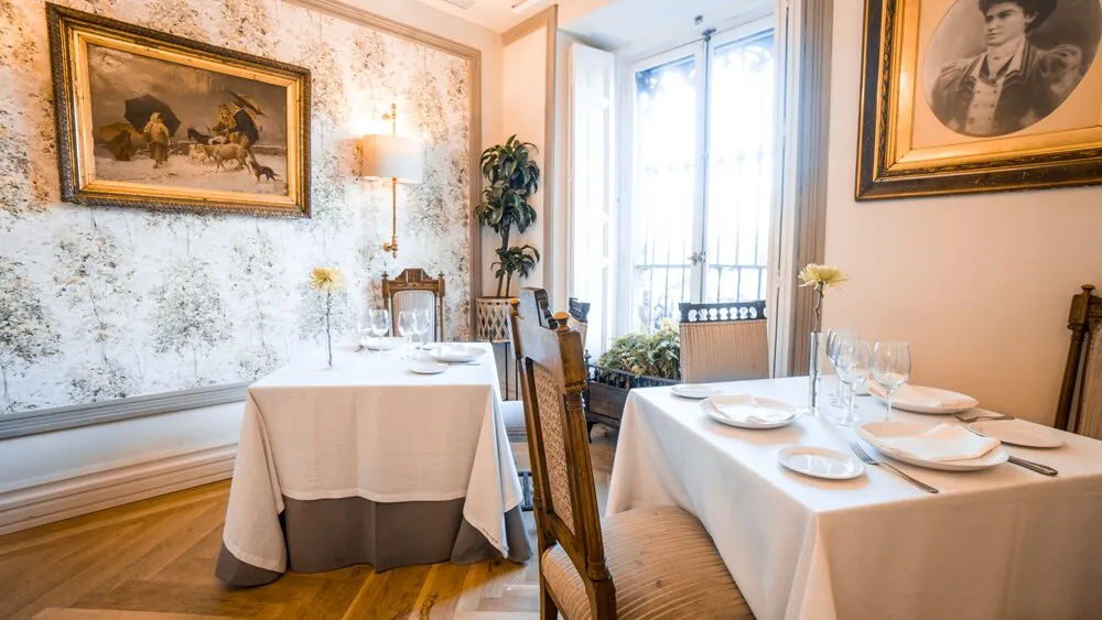White-clothed tables in a salon at Café de Oriente in Madrid