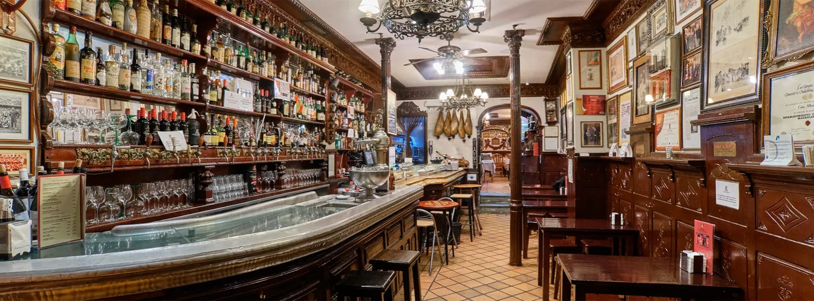 Bar and decorated-wall room at Casa Alberto, historic tavern in Madrid