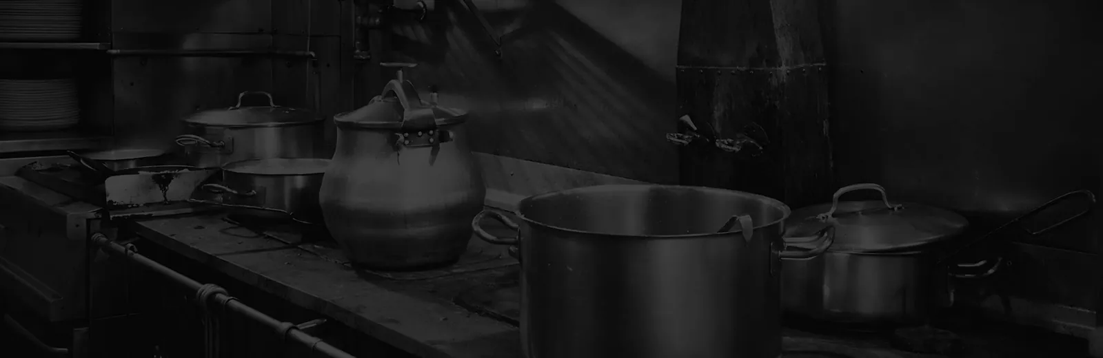 Kitchen of Casa Lucio restaurant in Madrid with stew pots and saucepans