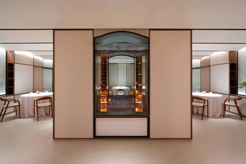 Cinc Sentits central dining room with a lit display case in Barcelona