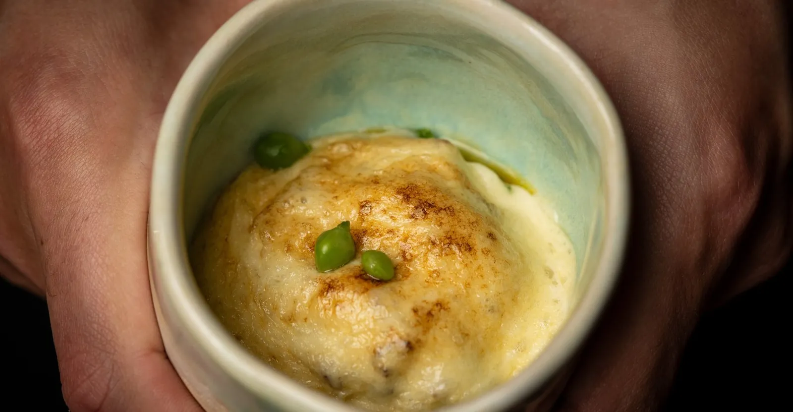 Dish served in a white bowl with peas at DINS Santi Taura in Palma