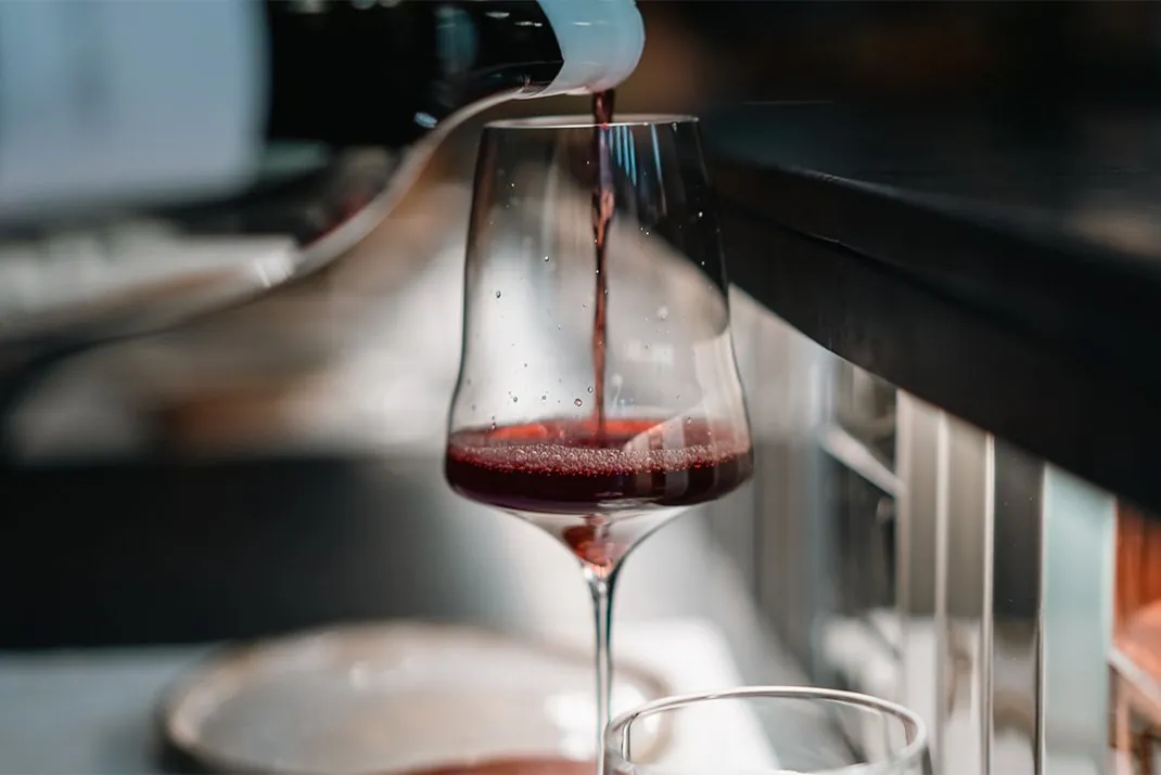 Red wine poured into a glass at DINS Santi Taura in Palma