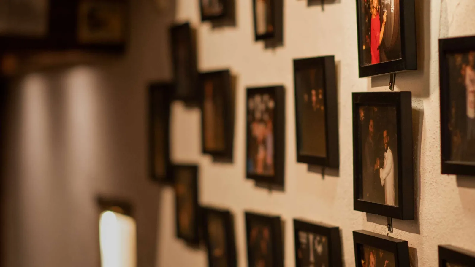 Wall covered with framed pictures inside El Pimpi restaurant in Málaga