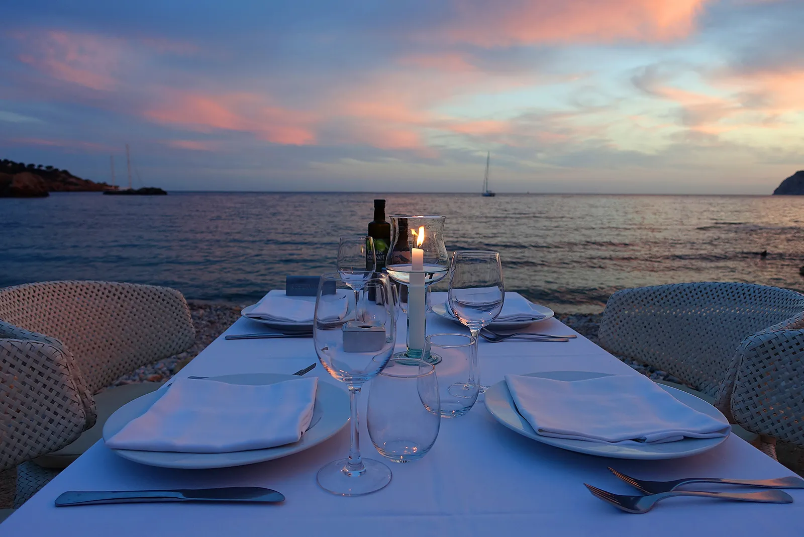 Table set facing the sunset over the sea at Es Torrent, Ibiza