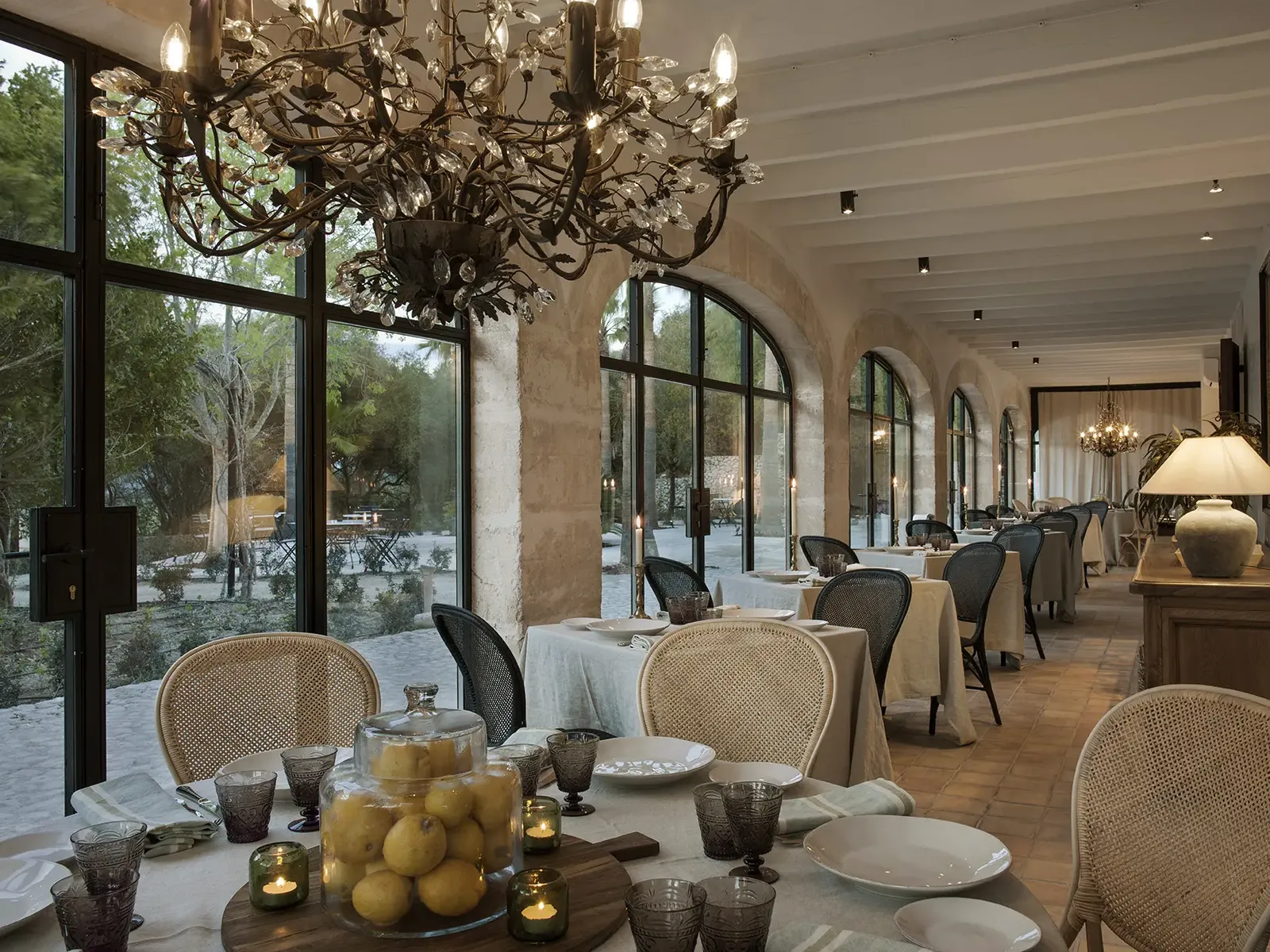Dining room at Finca Serena in Mallorca with ornate chandelier and set tables