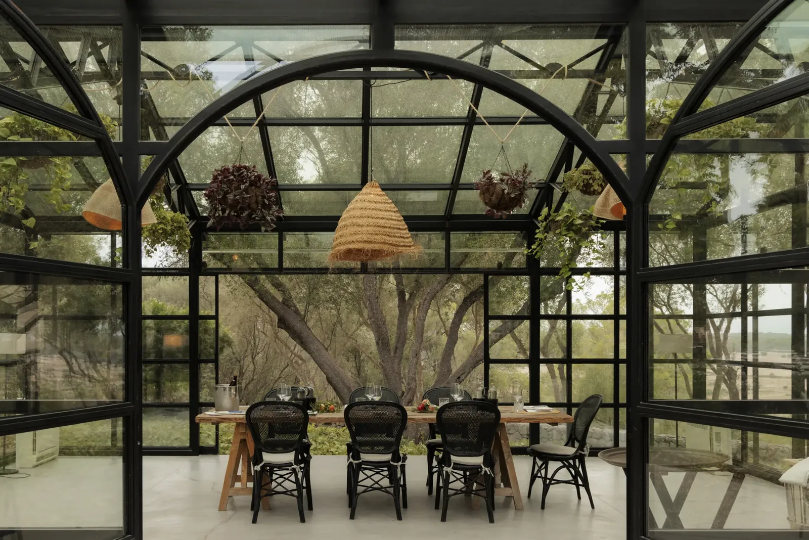 Glass-roofed dining room at Finca Serena in Mallorca with set tables