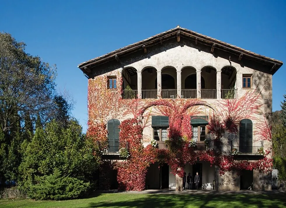 Stone and ivy façade of Les Cols restaurant in Olot