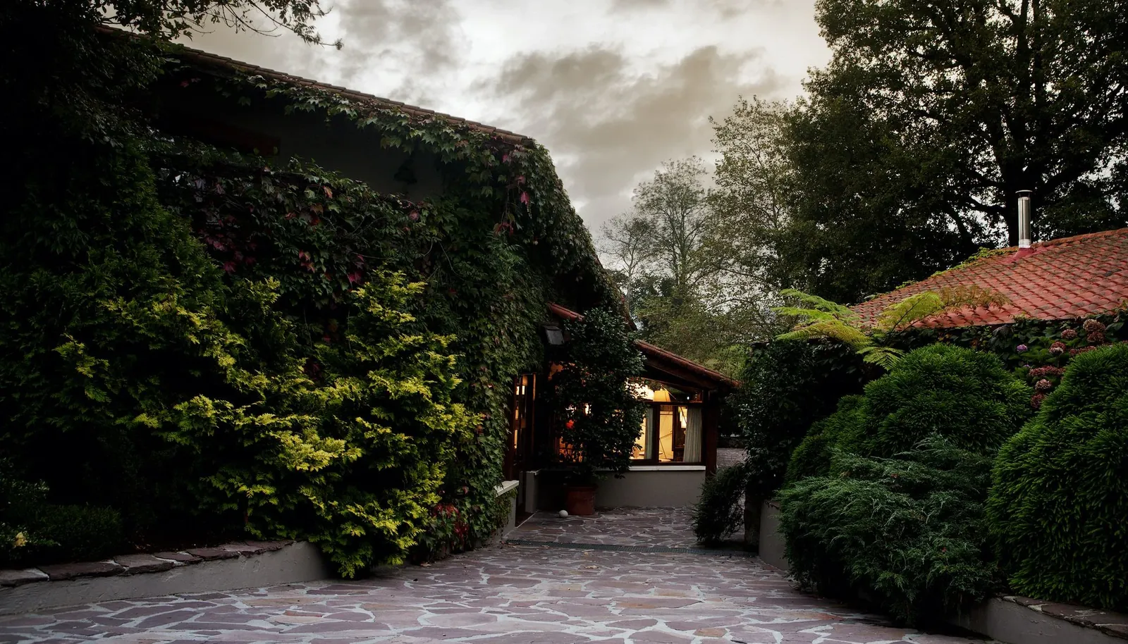 Entrance to Mugaritz restaurant, stone paving and ivy-covered walls in Errenteria