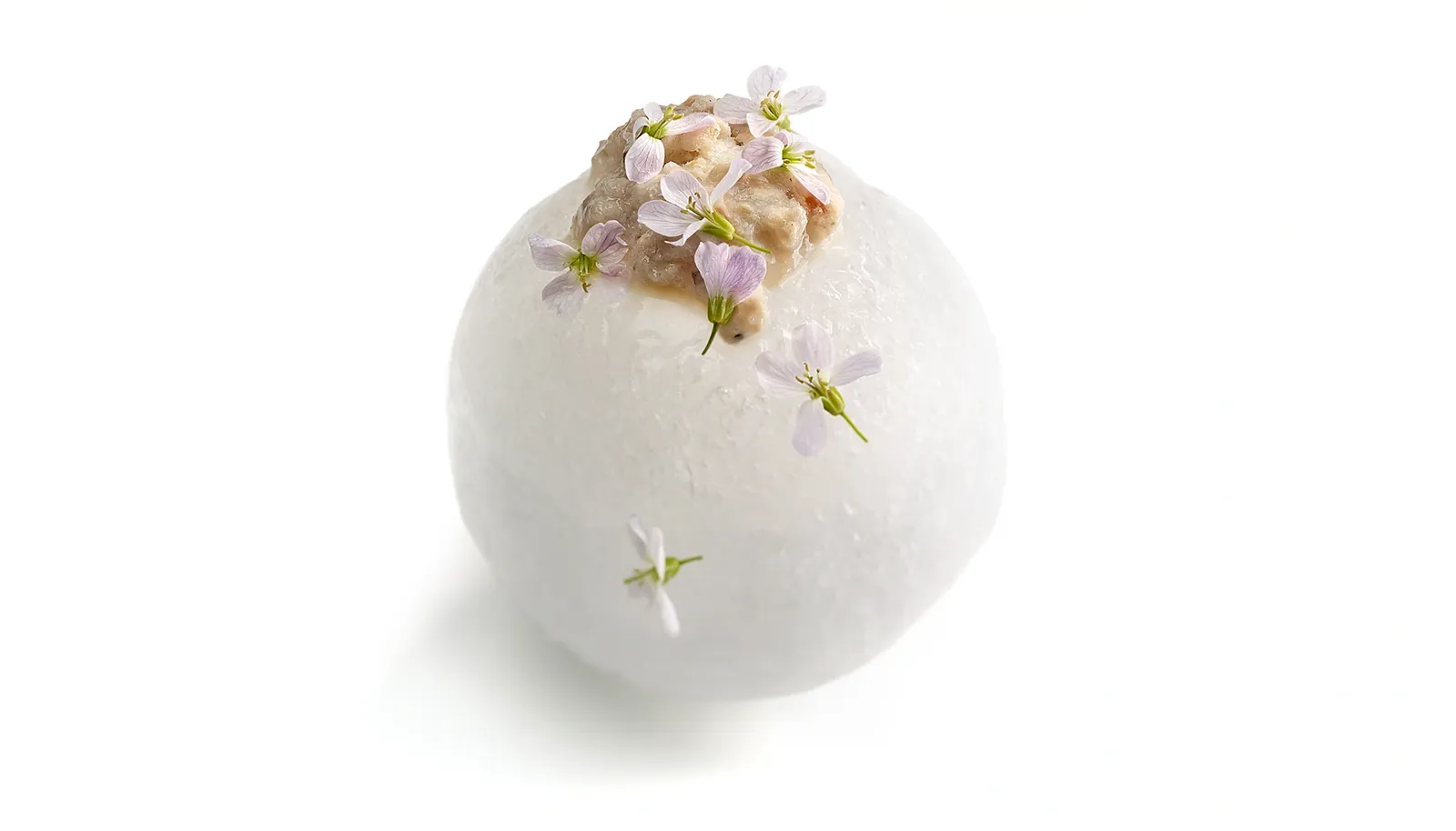 Mugaritz restaurant creation in Errenteria, white sphere topped with small flowers