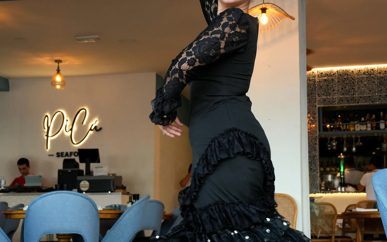 PiCú neon sign and flamenco dancer inside the PiCú Seafood restaurant in Marbella
