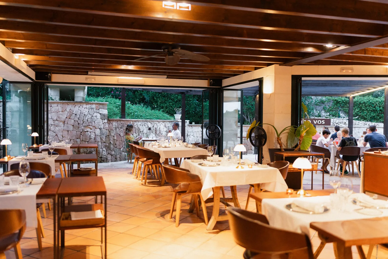 Bright dining room with set tables at Sa Pedrera d'es Pujol in Sant Lluís