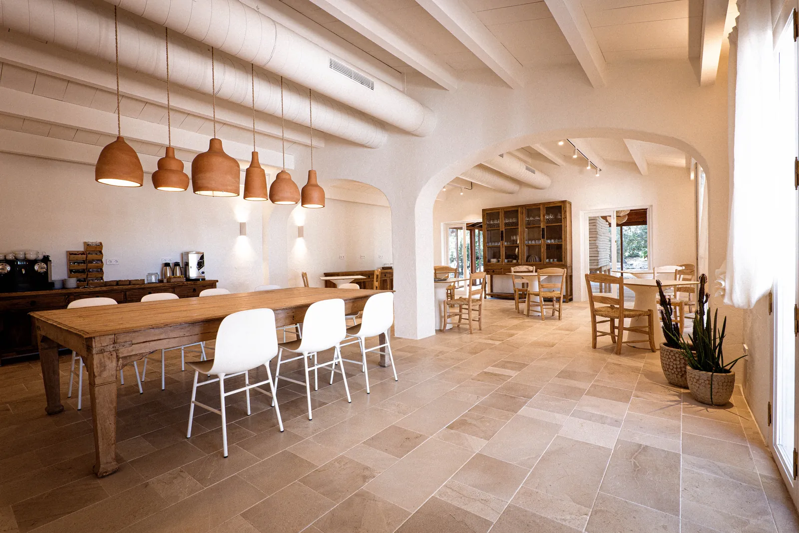 Smoix dining room with pendant lights and wooden table in Ciutadella