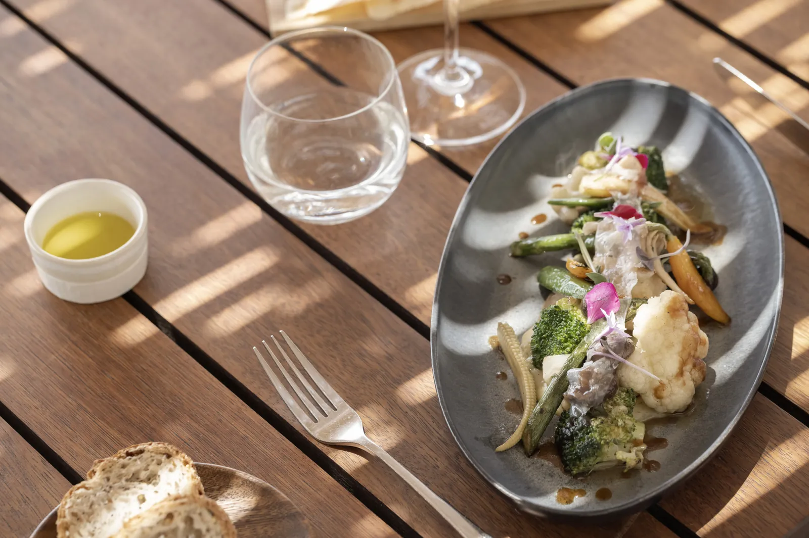 Dish of green vegetables and edible flowers at Torralbenc restaurant in Alaior