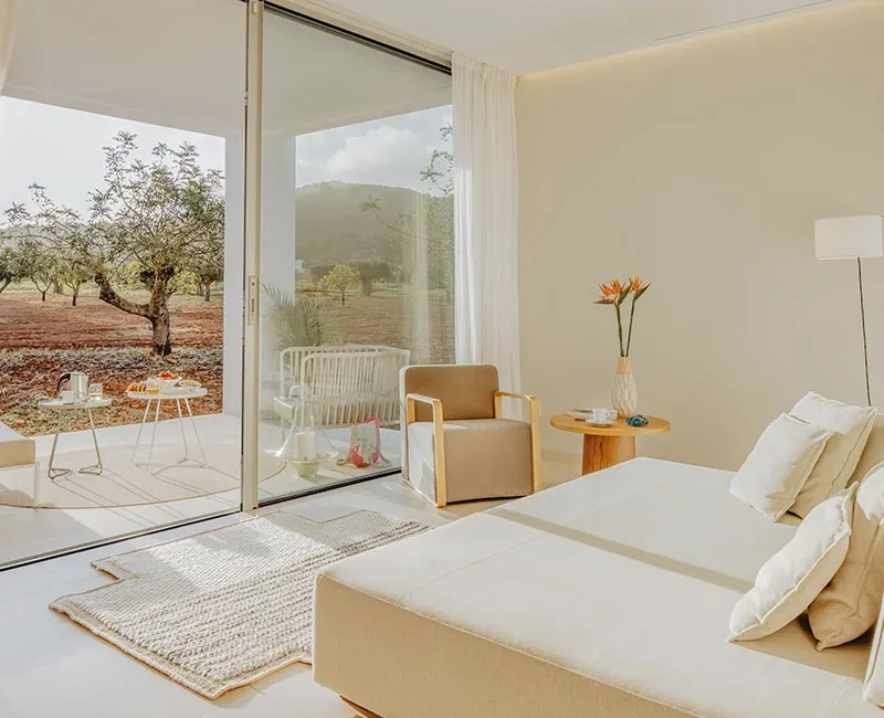 Bright room opening onto the olive garden at Ca Na Xica near Ibiza